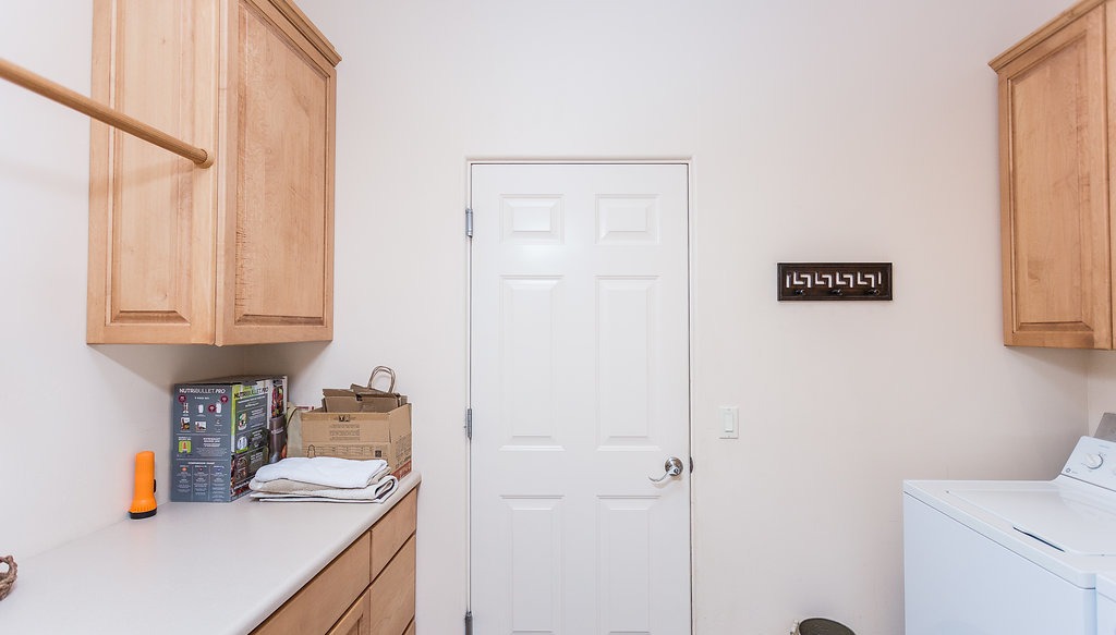 Laundry room with roomy countertop and full-size washer and dryer