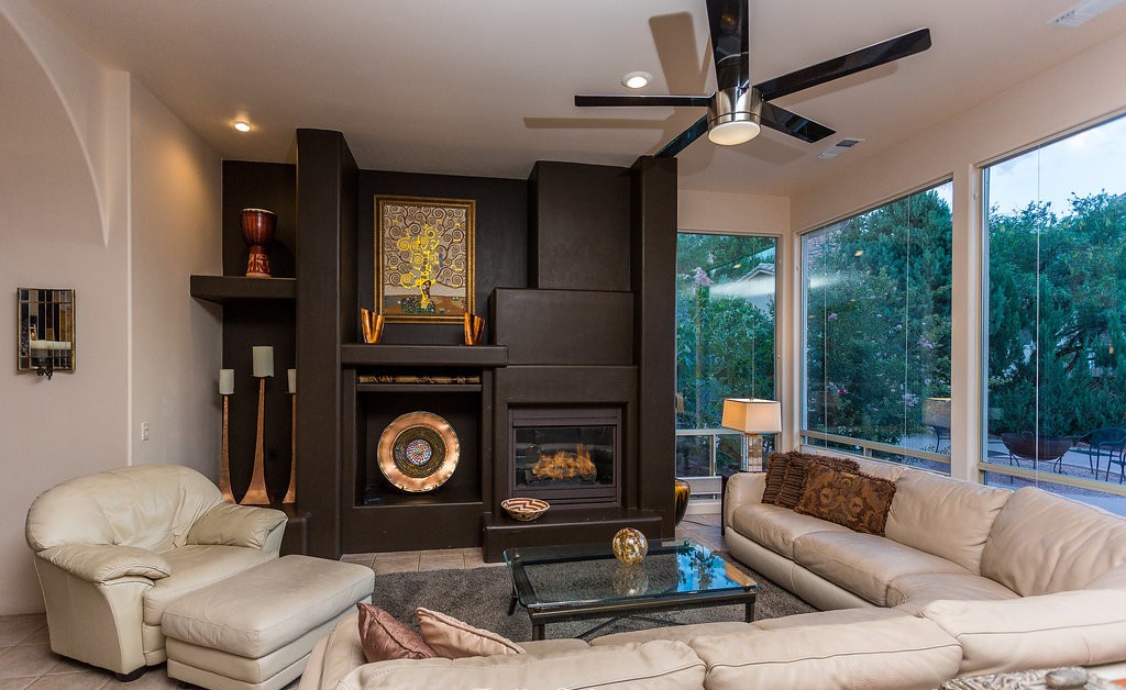 Living room at 60 Roundup Drive with fireplace and red rock views